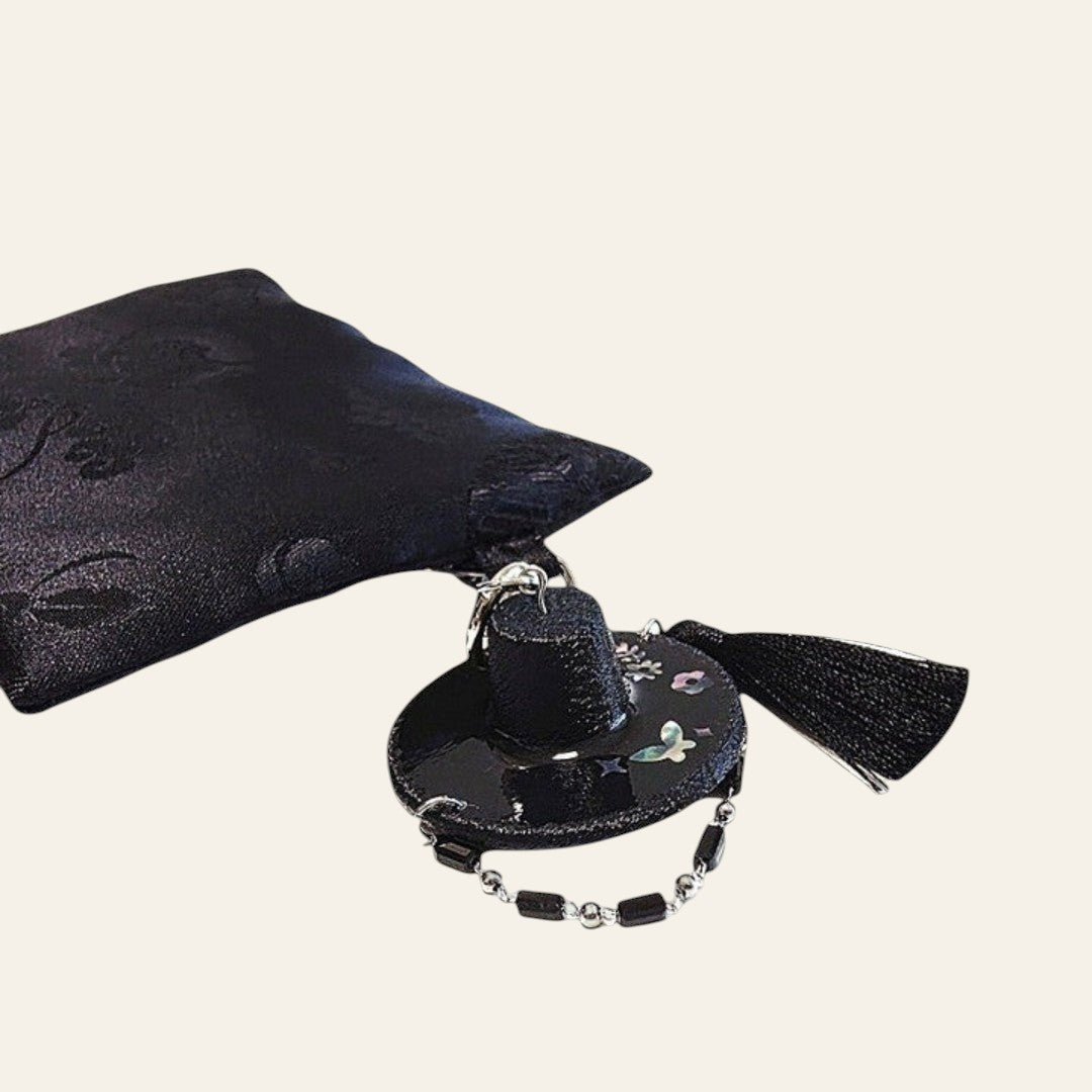 HanPorta black resin Gat hat keyring with iridescent mother-of-pearl butterfly inlay, beaded strap, and black tassel.