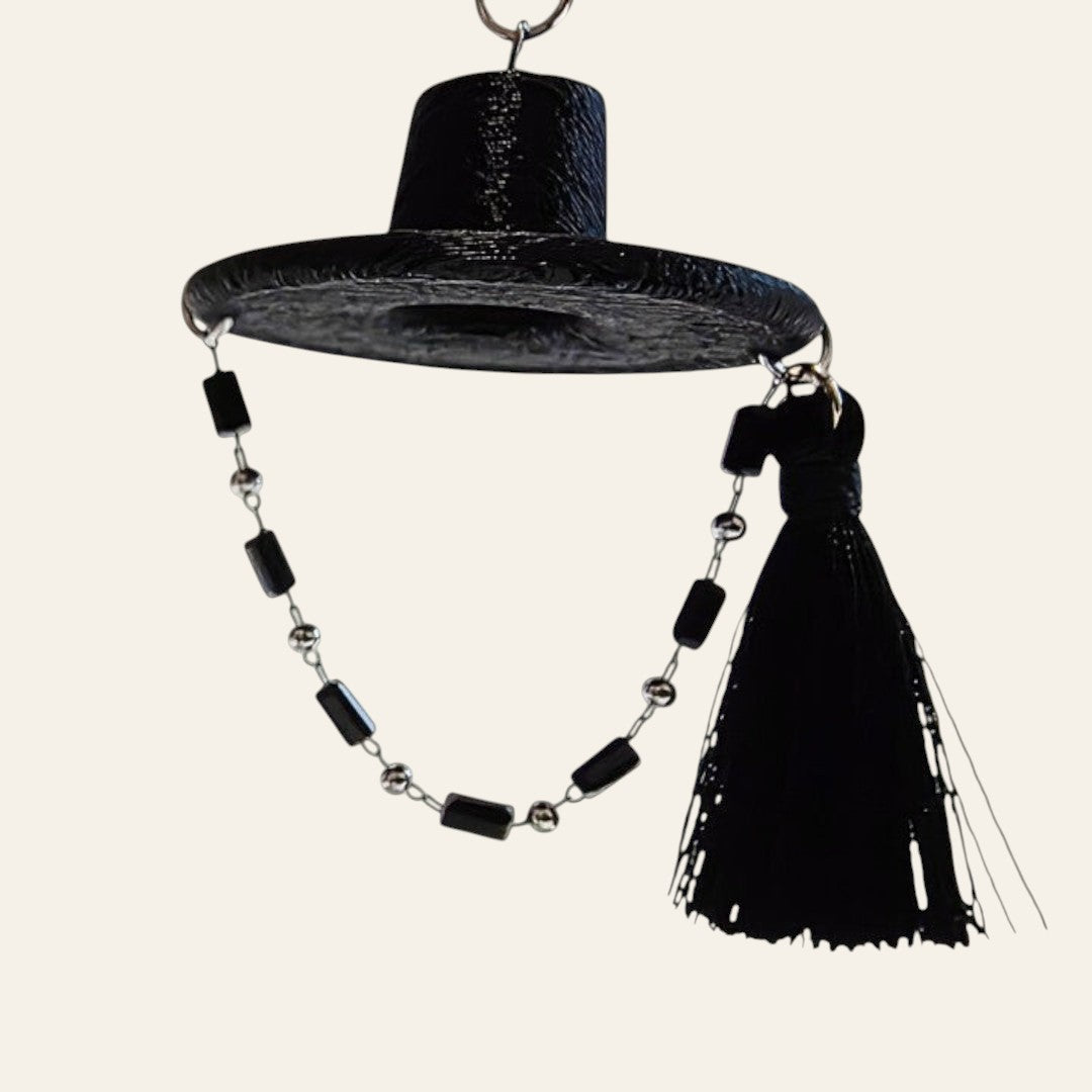 HanPorta black gat hat keyring with iridescent mother-of-pearl butterfly inlay, beaded strap, and elegant tassel.